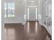 Elegant foyer with hardwood floors, white wainscoting, transom windows, and French doors to office at 1645 Dahlia Dr, Cumming, GA 30040