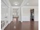 Hallway with hardwood floors, white trim, picture-frame molding, and French doors to adjacent room at 1645 Dahlia Dr, Cumming, GA 30040