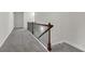 Hallway featuring gray carpet, white walls and a staircase with black wrought iron spindles at 1645 Dahlia Dr, Cumming, GA 30040
