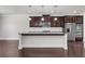 Modern kitchen with granite countertops, stainless appliances, and dark wood cabinets at 1645 Dahlia Dr, Cumming, GA 30040
