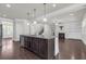 Spacious eat-in kitchen with hardwood floors, granite counters and stainless steel appliances at 1645 Dahlia Dr, Cumming, GA 30040