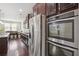 Modern kitchen with stainless steel appliances, dark cabinets, and a granite countertop at 1645 Dahlia Dr, Cumming, GA 30040