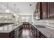 Gourmet kitchen features granite countertops, stainless steel appliances, and dark wood cabinets at 1645 Dahlia Dr, Cumming, GA 30040
