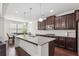 Bright kitchen showcasing a spacious island with granite countertops and stylish pendant lighting at 1645 Dahlia Dr, Cumming, GA 30040