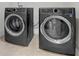 Modern laundry room with front loading washer and dryer at 1645 Dahlia Dr, Cumming, GA 30040