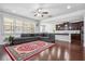 Open-concept living room with hardwood floors, a large sectional sofa, and a view of the kitchen at 1645 Dahlia Dr, Cumming, GA 30040