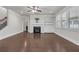 Bright living room features fireplace, built-in shelves and hardwood floors at 1645 Dahlia Dr, Cumming, GA 30040
