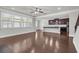 Open-concept living room with hardwood floors and adjacent kitchen at 1645 Dahlia Dr, Cumming, GA 30040