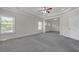 Large main bedroom with neutral carpet and trim, two large windows and view into sitting room at 1645 Dahlia Dr, Cumming, GA 30040