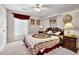 Comfortable bedroom with a queen bed, carpet, and ample lighting at 200 Boca Ciega Ct, Alpharetta, GA 30022