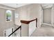 Upstairs hallway with crystal chandelier and view of the foyer at 200 Boca Ciega Ct, Alpharetta, GA 30022