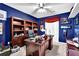 Office with ceiling fan, hardwood desk, built in shelves, and decorations at 200 Boca Ciega Ct, Alpharetta, GA 30022