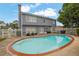 Large in-ground pool surrounded by a concrete patio and fenced yard at 200 Boca Ciega Ct, Alpharetta, GA 30022