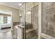 Modern bathroom featuring a glass-enclosed shower with tile surround and a glimpse of the soaking tub at 25 High Gate Trail, Atlanta, GA 30030