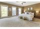 A spacious bedroom has plush carpet, three bright windows, and neutral decor at 25 High Gate Trail, Atlanta, GA 30030
