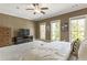 A spacious primary bedroom is fitted with carpet, three bright windows, and neutral decor at 25 High Gate Trail, Atlanta, GA 30030