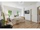 This stylish bedroom has light-colored wooden floors, large windows, and a flatscreen TV for ultimate comfort and entertainment at 25 High Gate Trail, Atlanta, GA 30030