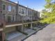 An exterior elevation showcasing the architecture of modern townhomes with drive-under garages and balconies at 25 High Gate Trail, Atlanta, GA 30030