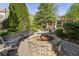 Community outdoor area with a brick firepit and seating, surrounded by manicured landscaping and mature trees at 25 High Gate Trail, Atlanta, GA 30030