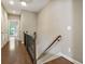Hallway with wood floors and stairs with wooden railing. Neutral colored walls at 25 High Gate Trail, Atlanta, GA 30030