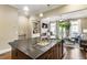 Open layout featuring a kitchen with granite counters that flows into the living room with fireplace at 25 High Gate Trail, Atlanta, GA 30030