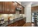 Updated kitchen boasts dark wood cabinets, stainless steel appliances, and tiled backsplash at 25 High Gate Trail, Atlanta, GA 30030