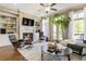 Cozy living room featuring a fireplace, built-in shelves, and a seamless flow to the outdoor balcony at 25 High Gate Trail, Atlanta, GA 30030
