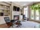 Inviting living room with a cozy fireplace, built-in shelving, and natural light at 25 High Gate Trail, Atlanta, GA 30030
