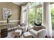 Comfortable sitting room with matching chairs, modern lighting, and balcony access at 25 High Gate Trail, Atlanta, GA 30030