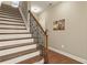 Elegant staircase featuring hardwood steps, white risers and a dark wood handrail with iron spindles at 25 High Gate Trail, Atlanta, GA 30030