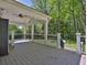 Covered back porch with a ceiling fan, black railings, and stairs to the backyard at 3090 Thrasher Nw Ct, Kennesaw, GA 30144
