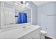 Bathroom with a large mirror over a vanity, and shower/tub with blue curtain at 3090 Thrasher Nw Ct, Kennesaw, GA 30144