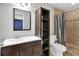 Bathroom with a double sink vanity, and a shower/tub with striped curtain at 3090 Thrasher Nw Ct, Kennesaw, GA 30144