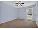 This bedroom features carpet flooring, light blue walls, ceiling fan, and a window at 3090 Thrasher Nw Ct, Kennesaw, GA 30144