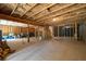 Unfinished basement with exposed ceiling, wood frame structure, and concrete floor ready for customization at 460 Marston Pass, Acworth, GA 30102