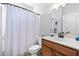 Cozy bathroom with a shower-tub combo, wooden vanity, and a bright, clean aesthetic at 460 Marston Pass, Acworth, GA 30102