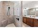 This bathroom has a tiled shower with a dark fixture and a vanity with a solid surface countertop at 460 Marston Pass, Acworth, GA 30102