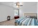 Comfortable bedroom with carpet, ceiling fan, and natural light from the large windows at 460 Marston Pass, Acworth, GA 30102