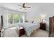 Serene bedroom featuring a tufted headboard, soft carpeting, and a large window for lots of natural light at 460 Marston Pass, Acworth, GA 30102