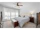 Serene bedroom featuring a tufted headboard, soft carpeting, and a large window for lots of natural light at 460 Marston Pass, Acworth, GA 30102