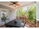 Outdoor view of a wooden deck, ceiling fan, outdoor seating, table, potted tree and trees at 460 Marston Pass, Acworth, GA 30102