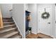 A home's entryway with hard surface floors, stairs, coat rack, and a decorated door at 460 Marston Pass, Acworth, GA 30102