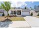 Inviting home showcasing a columned front porch, a two-car garage, and landscaped front yard at 460 Marston Pass, Acworth, GA 30102
