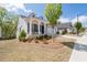 Attractive home with a charming front porch, a well-kept lawn, and an attached two-car garage at 460 Marston Pass, Acworth, GA 30102