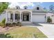 Charming home features a welcoming front porch, a two-car garage, and a well-manicured lawn at 460 Marston Pass, Acworth, GA 30102
