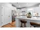 Modern white kitchen with quartz counters, stainless steel appliances and a large island at 460 Marston Pass, Acworth, GA 30102