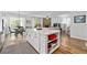 Open-concept kitchen with a large island, hardwood floors, and a view to the living room at 460 Marston Pass, Acworth, GA 30102