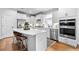 Bright white kitchen with stainless appliances, quartz counters, large island and seating at 460 Marston Pass, Acworth, GA 30102