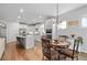 Bright, open kitchen and dining area with hardwood floors, stainless steel appliances, and modern fixtures at 460 Marston Pass, Acworth, GA 30102
