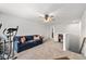 Upstairs living room with sofa and ceiling fan; exercise equipment is also staged in this room at 460 Marston Pass, Acworth, GA 30102